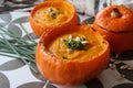 Creamy pumpkin soup and homemade bread on grey tiled table. Soup in a squash top view photo. Thanksgiving menu ideas.ÃÂ ÃÂ  Royalty Free Stock Photo